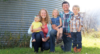 Huber Family posing by a grain bin